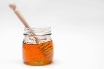 honey in jar on white background