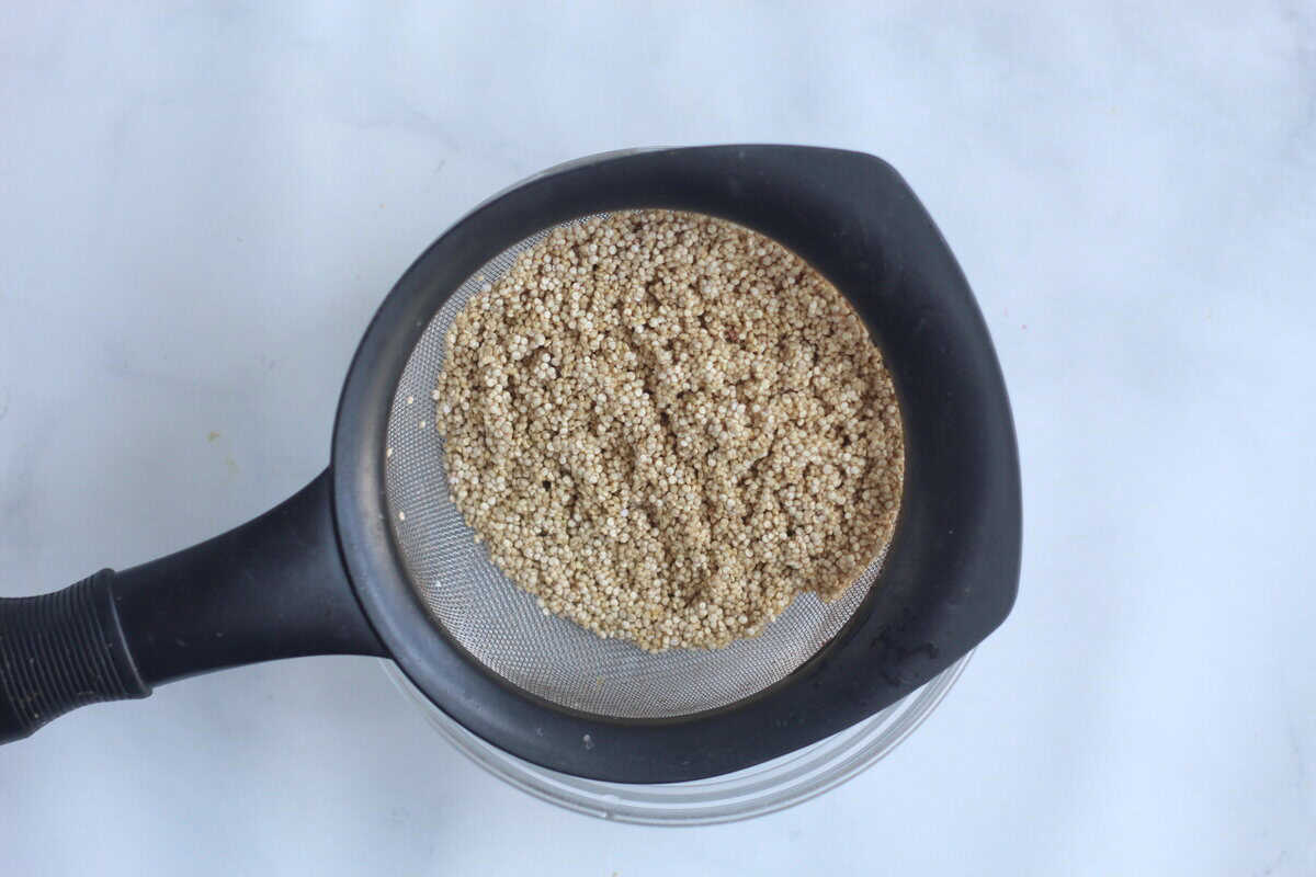 Quinoa in strainer for quinoa pudding.
