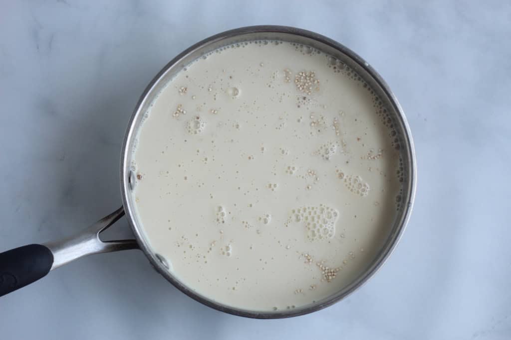 Liquid ingredients in pot for quinoa pudding.