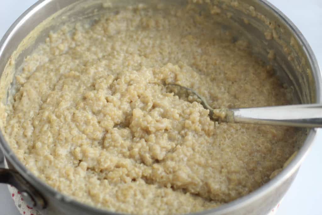 quinoa pudding in a pot with spoon.