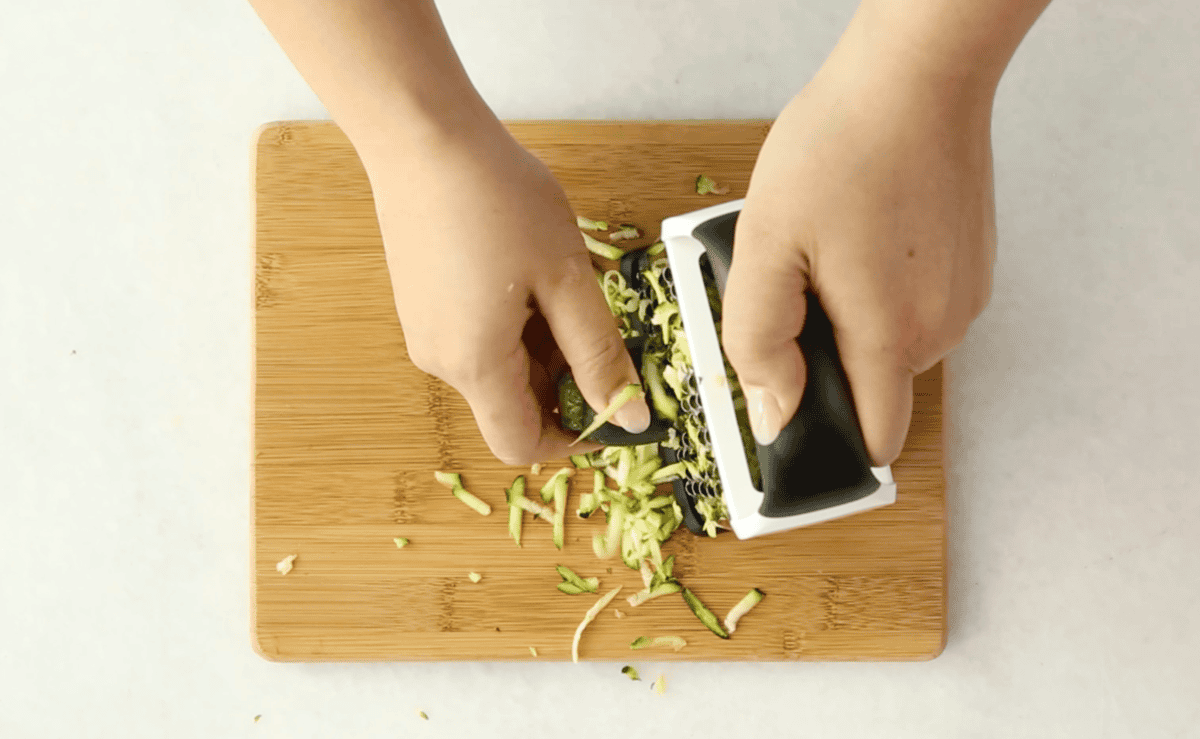 Shredding zucchini for zucchini carrot muffins. 