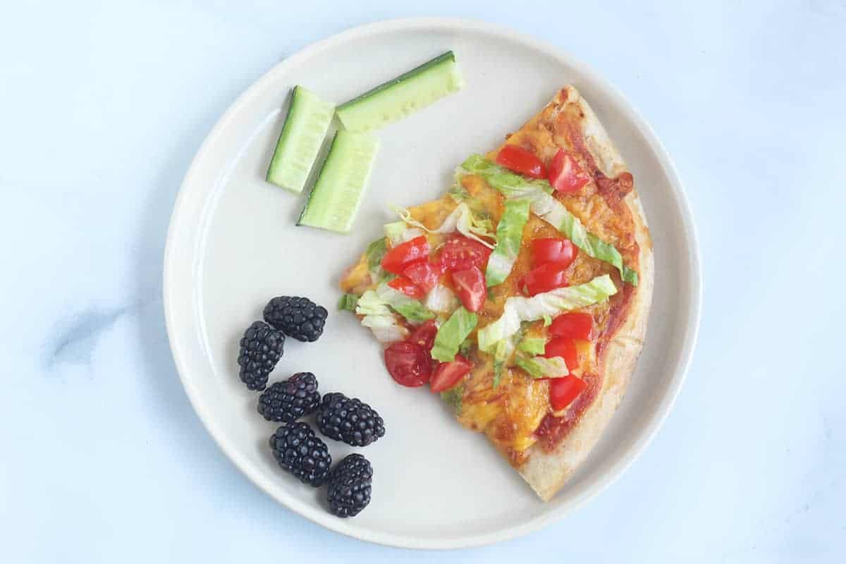 mexican-flatbread-pizza on plate with berries