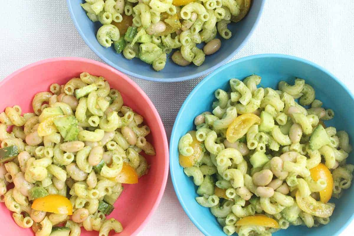 pesto pasta salad in colored kids bowls