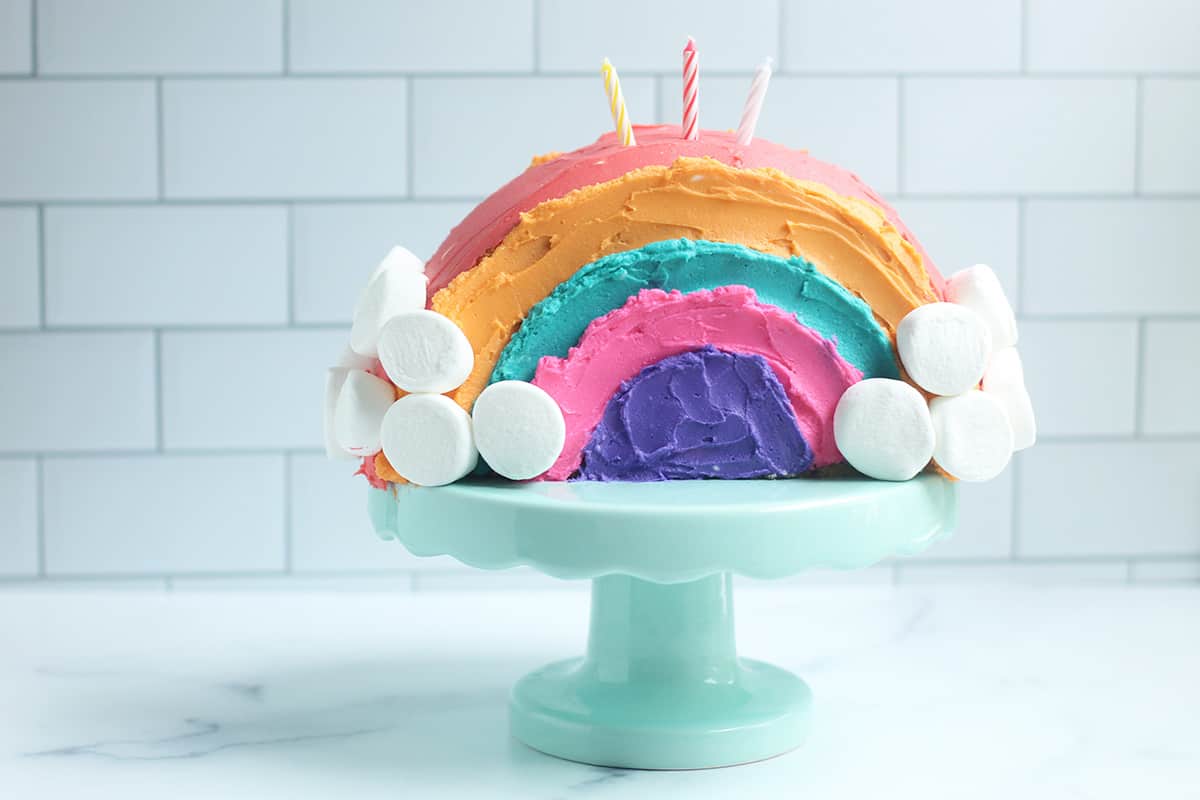 rainbow cake with candleson cake stand