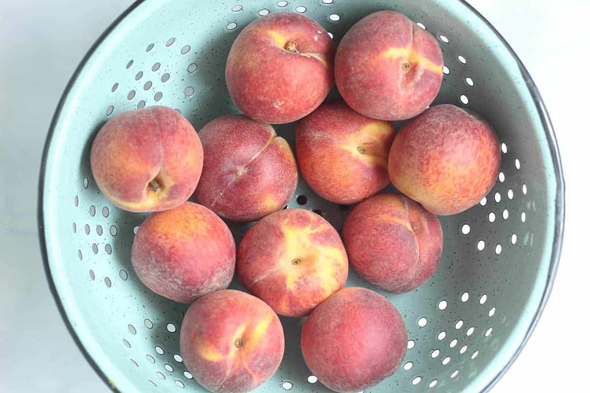 fresh peaches in colander