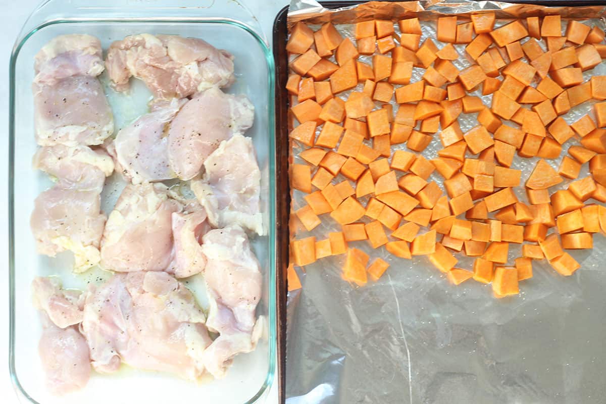 chicken thighs and sweet potato on trays for the oven.