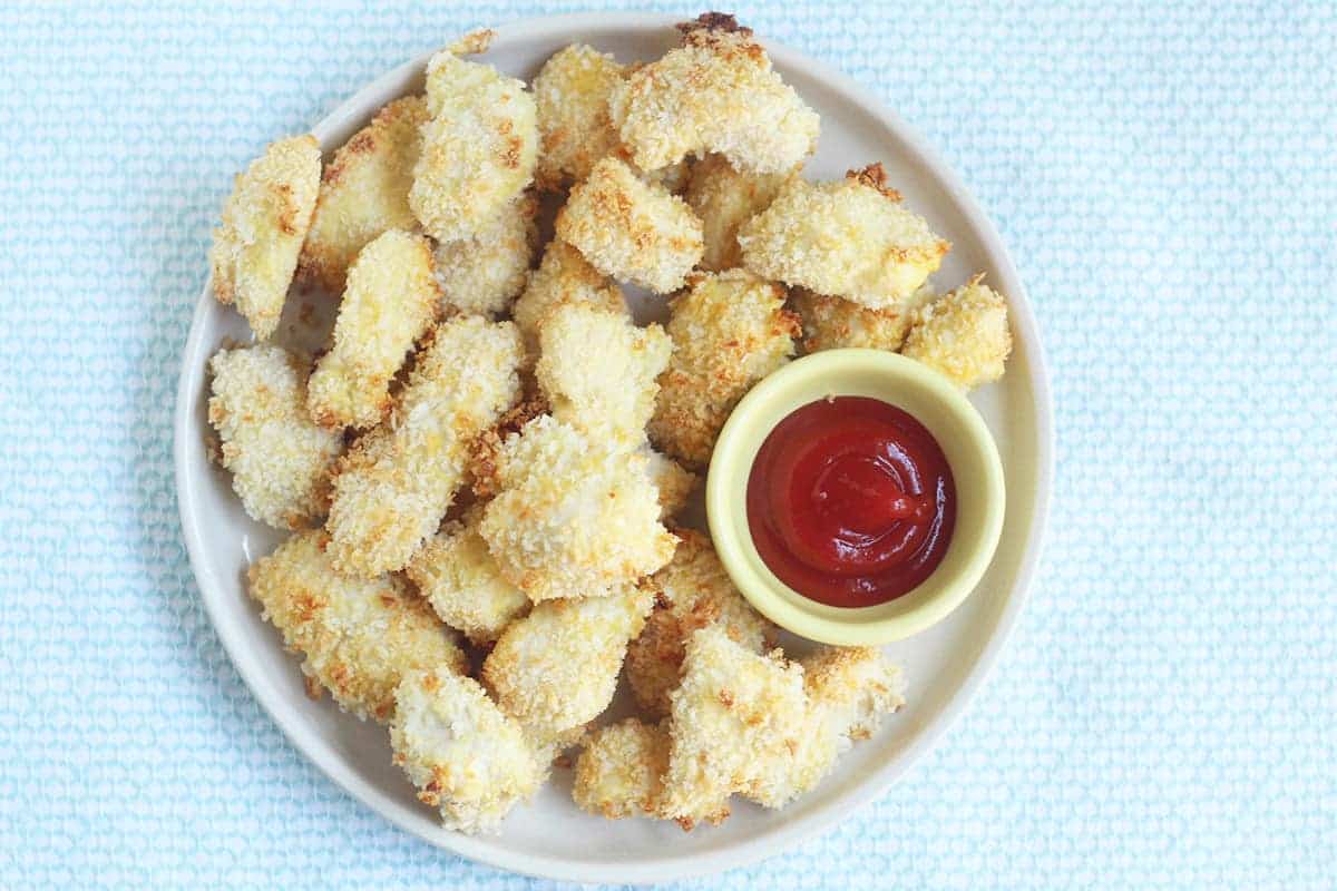 baked chicken nuggets on plate with ketchup
