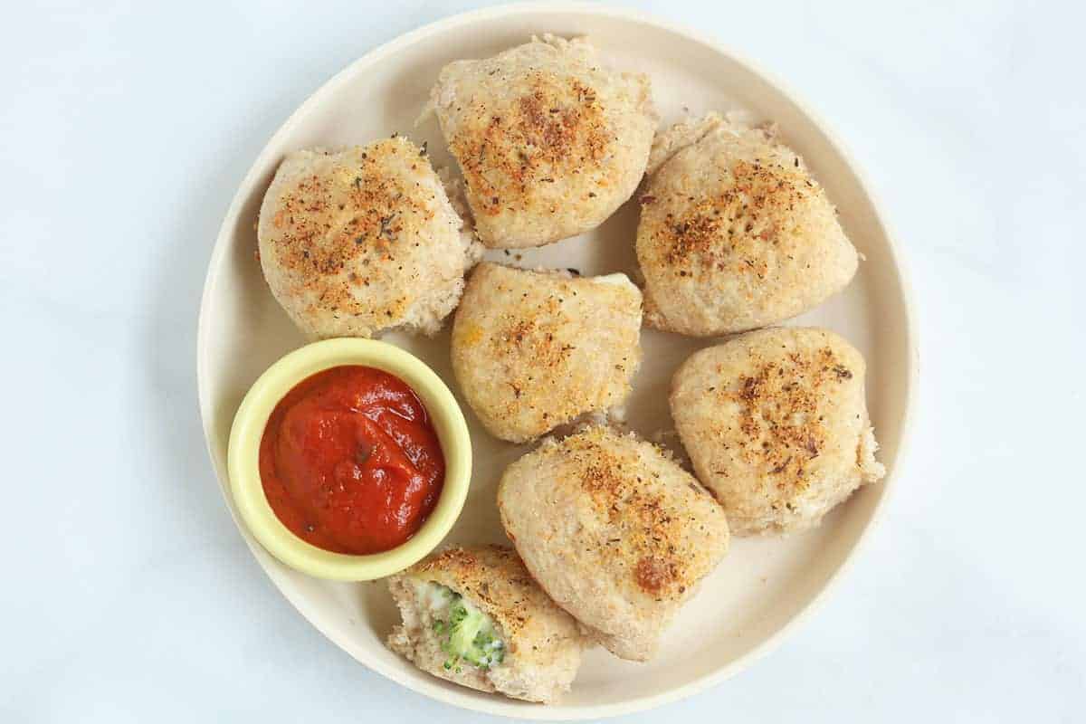 pizza bites on plate with pizza sauce