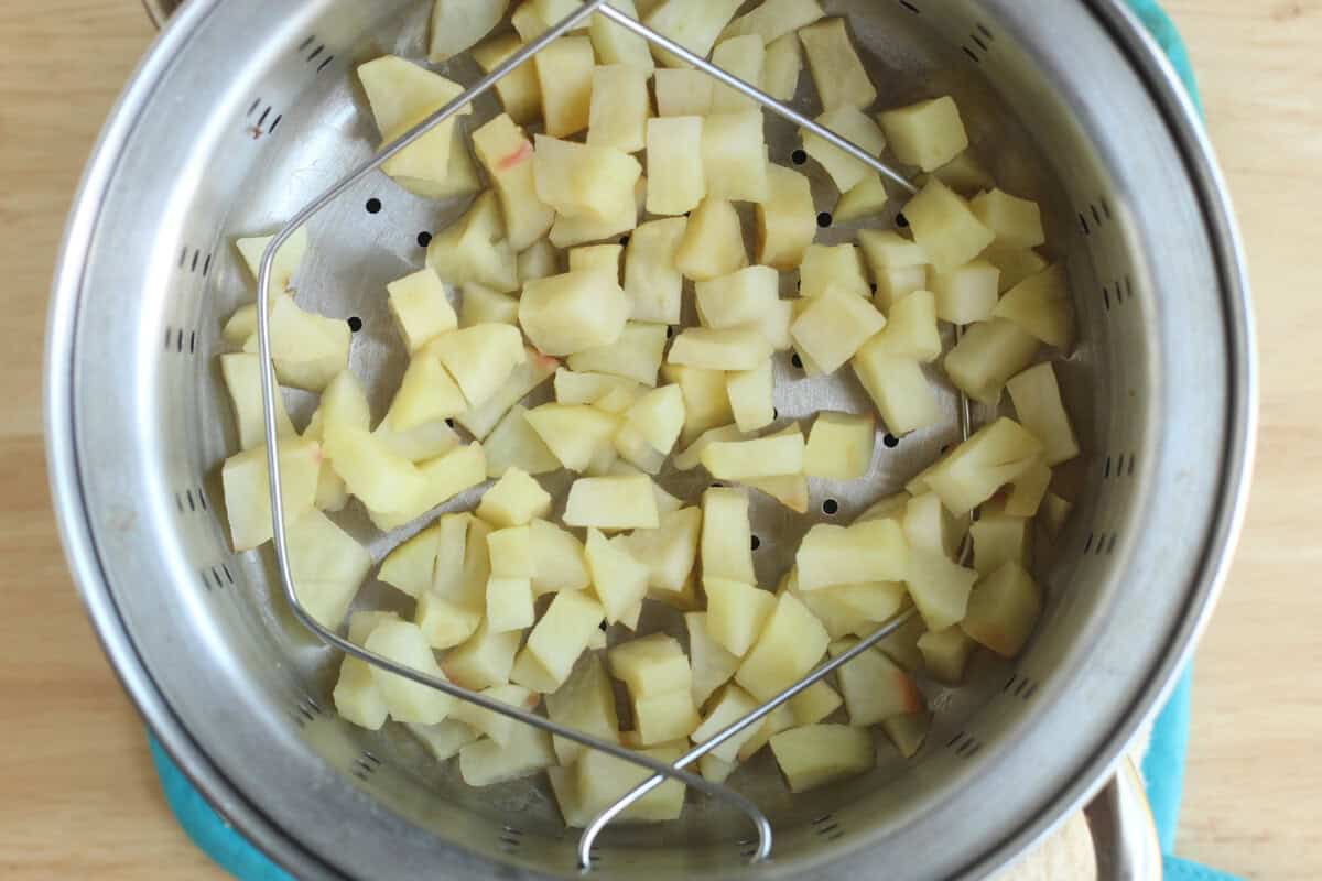 Chopped apples in steaming pot for apple puree.
