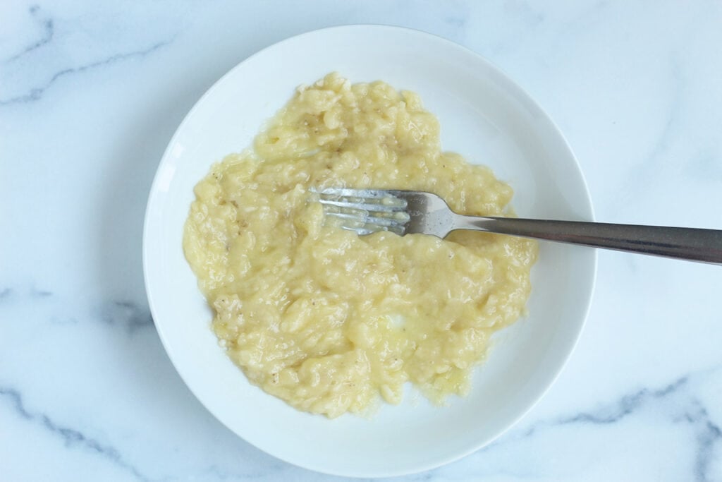 mashed banana in white bowls.