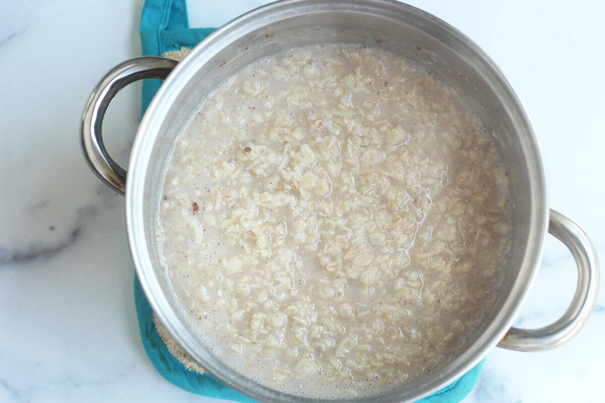cooked oats in pot of water.