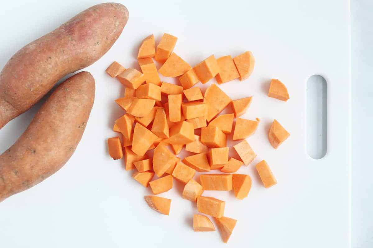 diced sweet potato on white cutting board