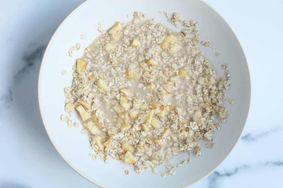 making apple instant oats in white bowl
