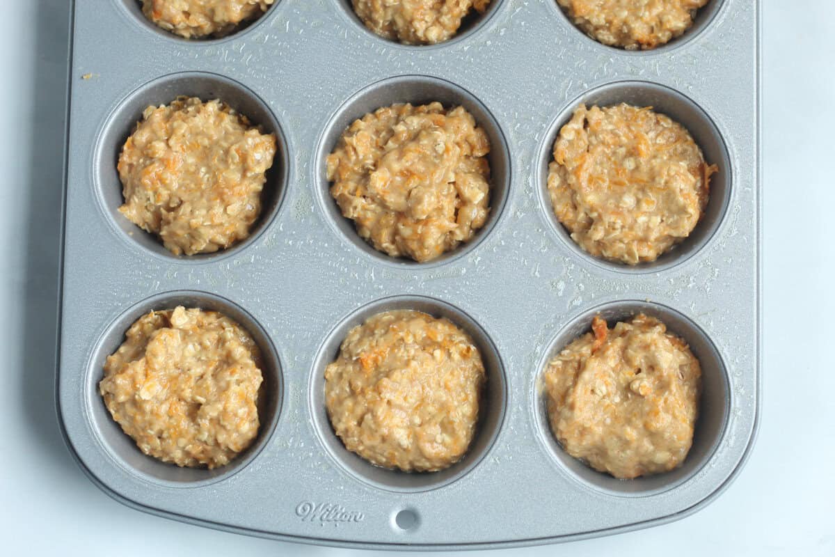 Butternut squash muffins in muffin pan before baking.