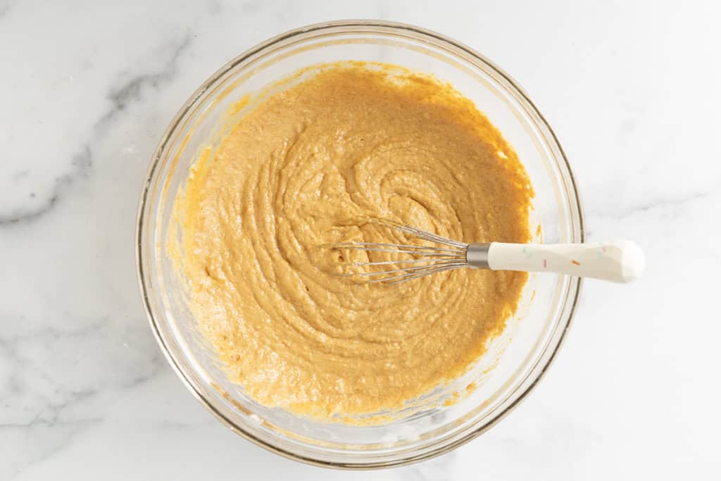 Batter for sweet potato waffles in glass bowl.