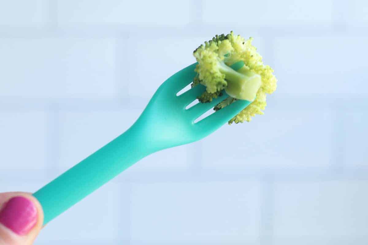 broccoli on teal fork.