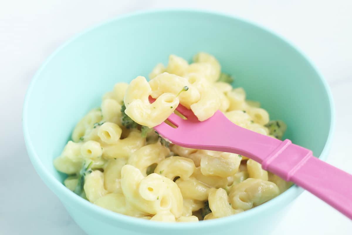 broccoli mac and cheese in blue kids bowl