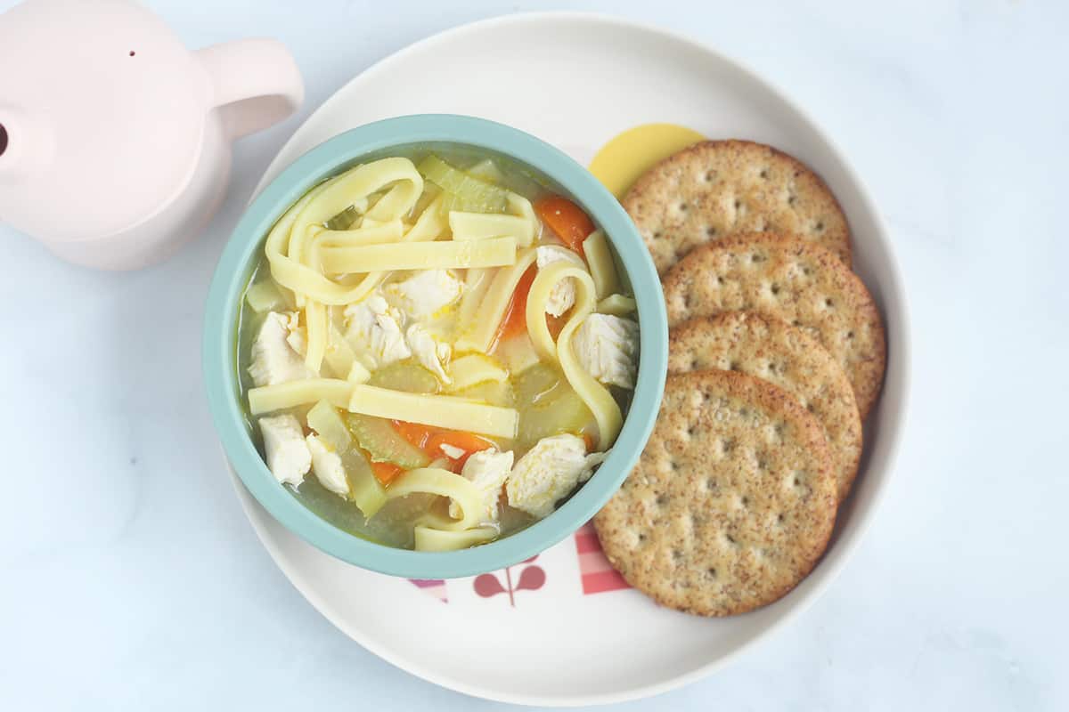 chicken soup in bowls with crackers.