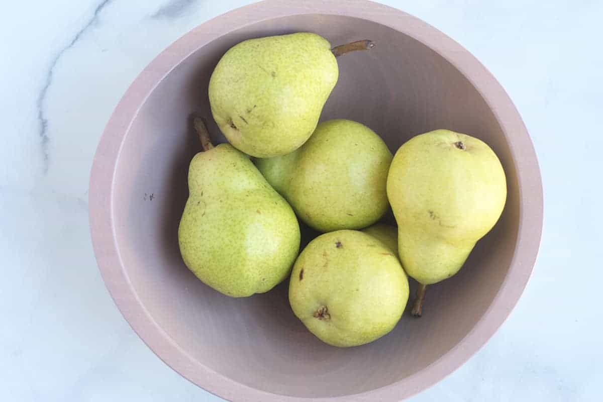 bartlett pears in pink bowl