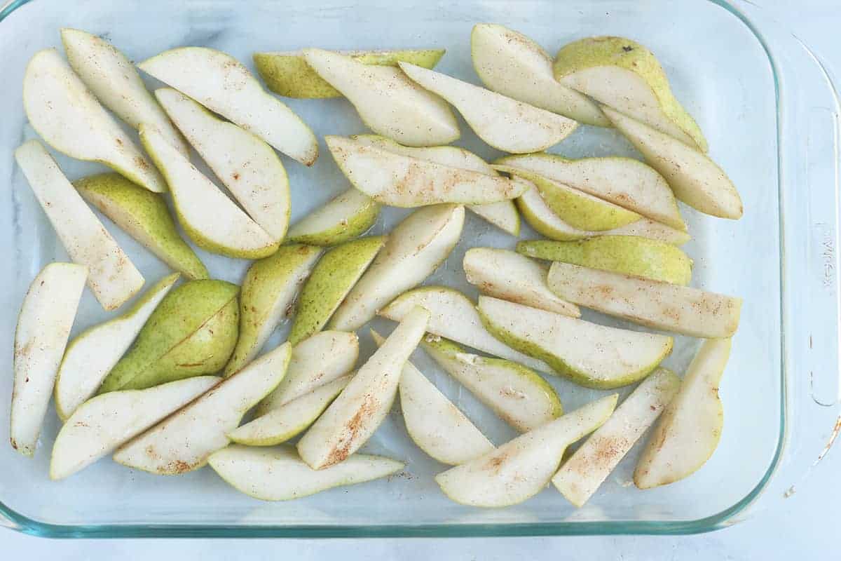pear slices in baking dish with cinnamon
