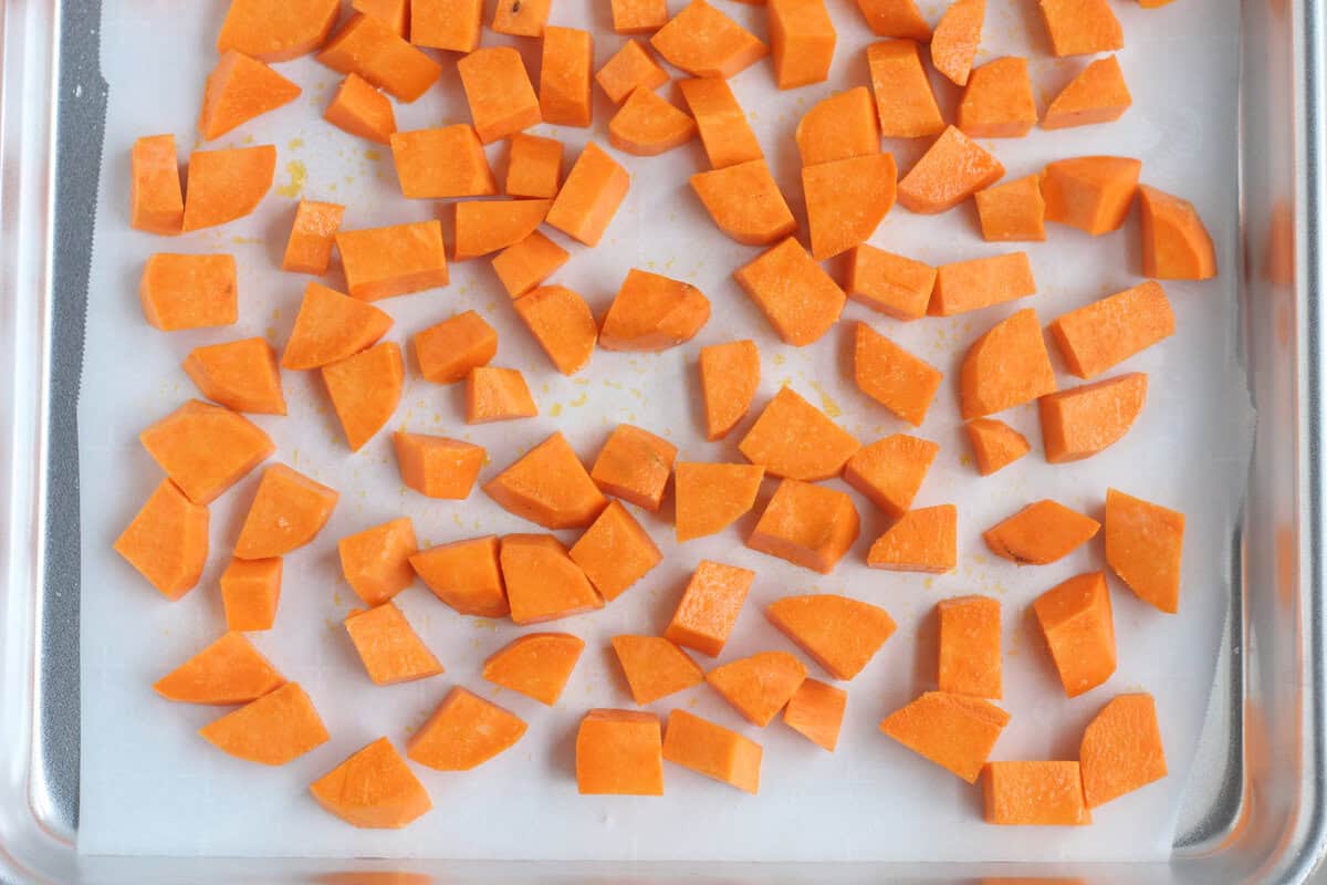 Chopped sweet potatoes on pan for roasted sweet potatoes.