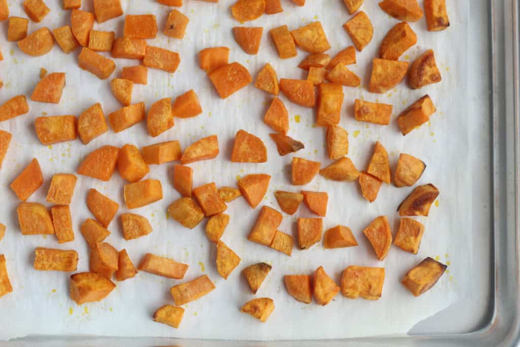 Roasted sweet potatoes on sheet pan.