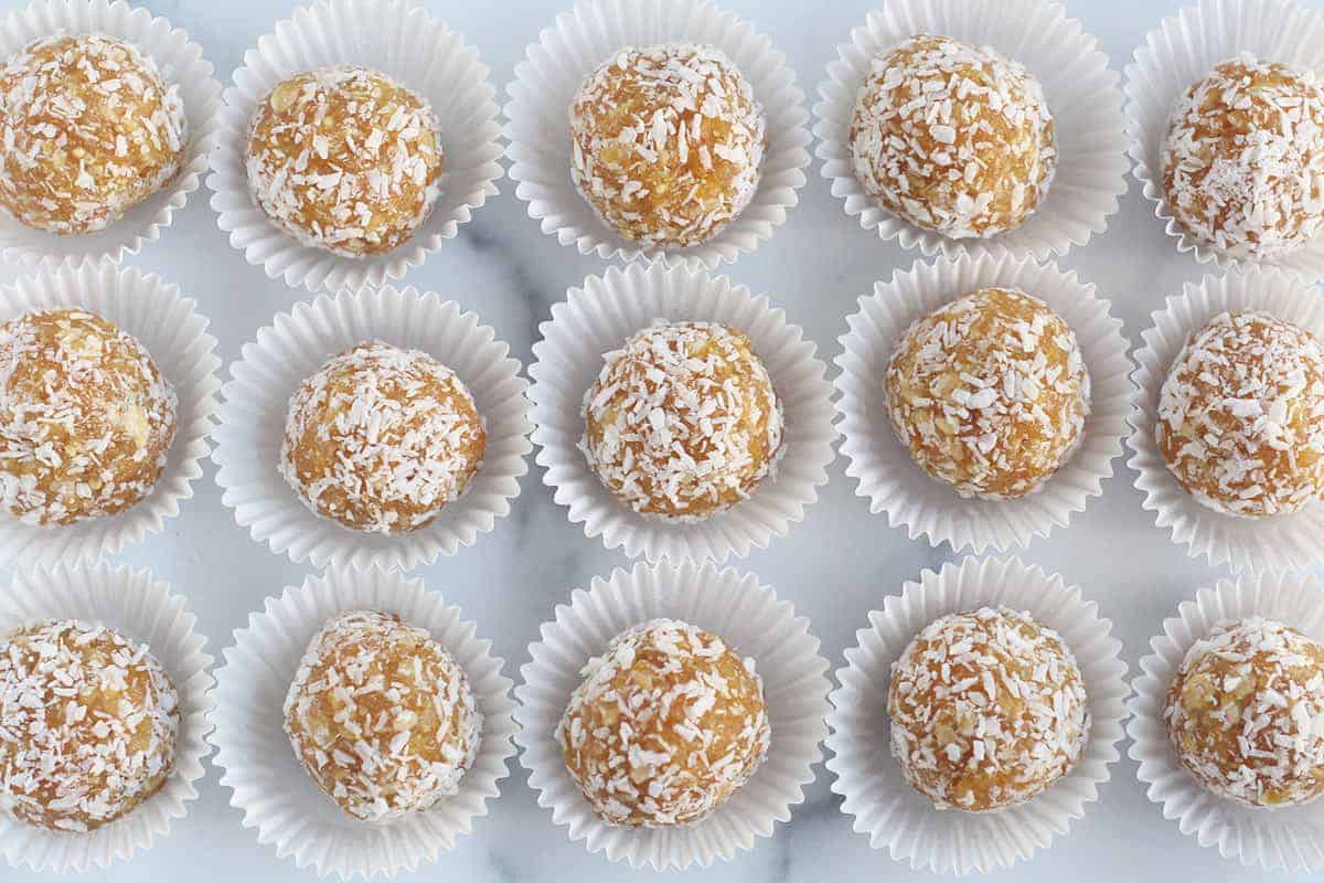 apricot balls with coconut in paper cups