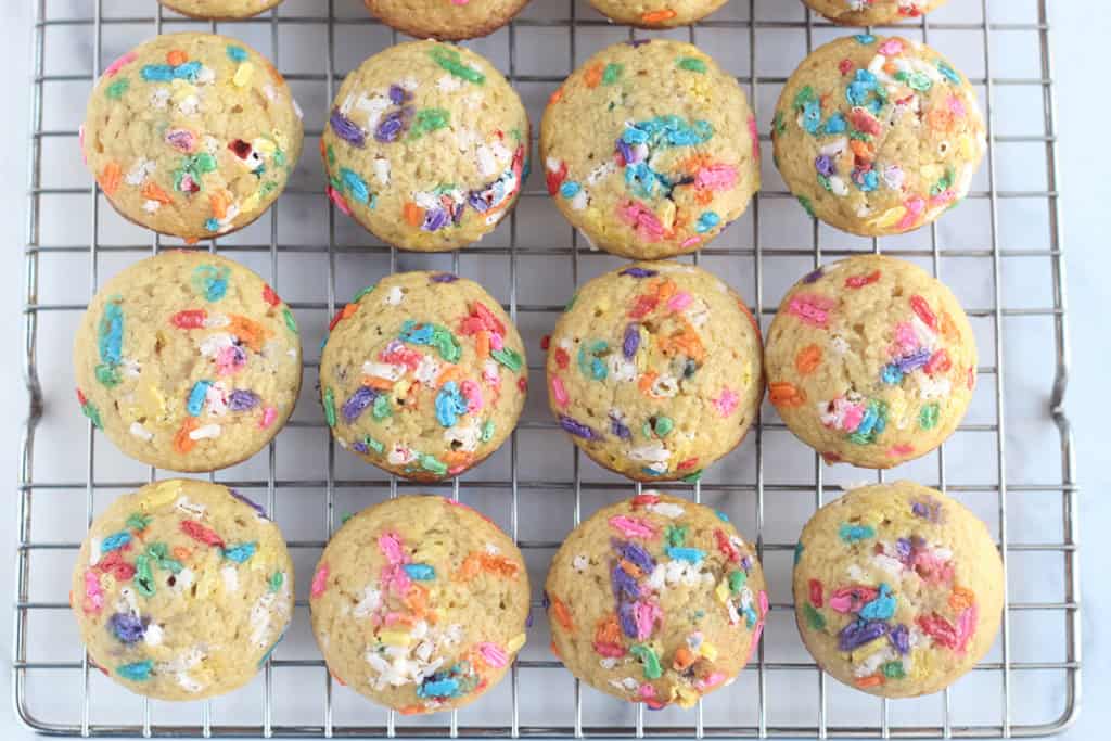 Birthday cake muffins on cooling rack.
