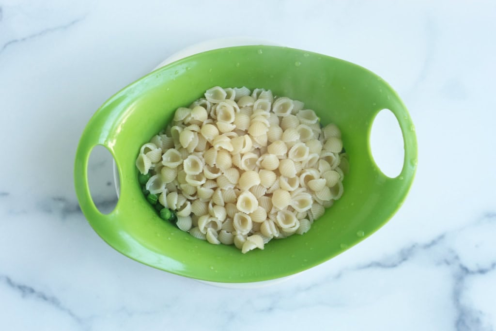 pasta in a strainer for mac and cheese.