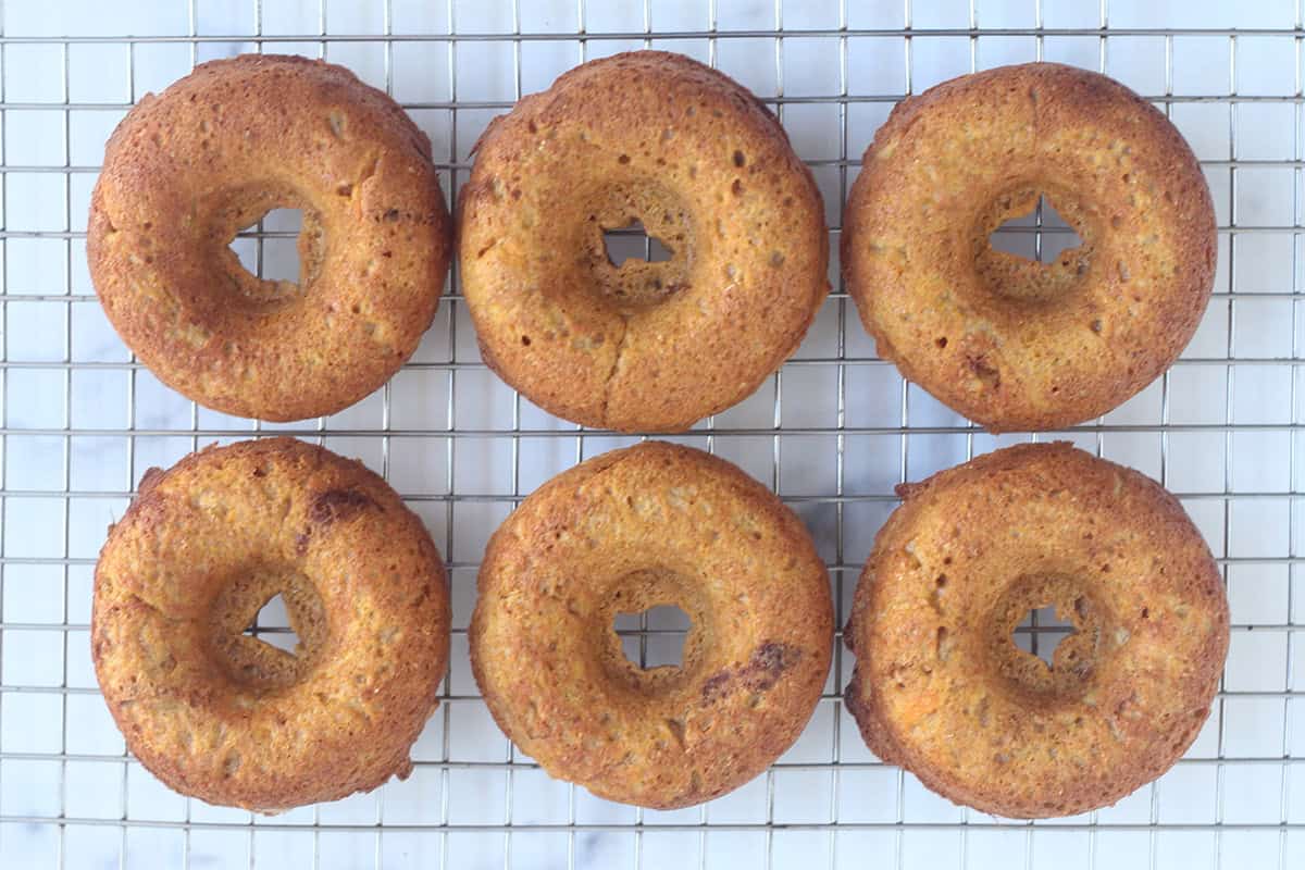 Sweet potato donuts on cooling rack.