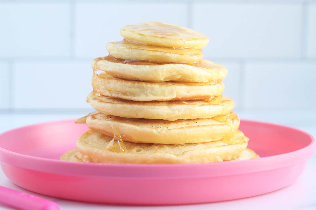 stack of yogurt pancakes on pink plate