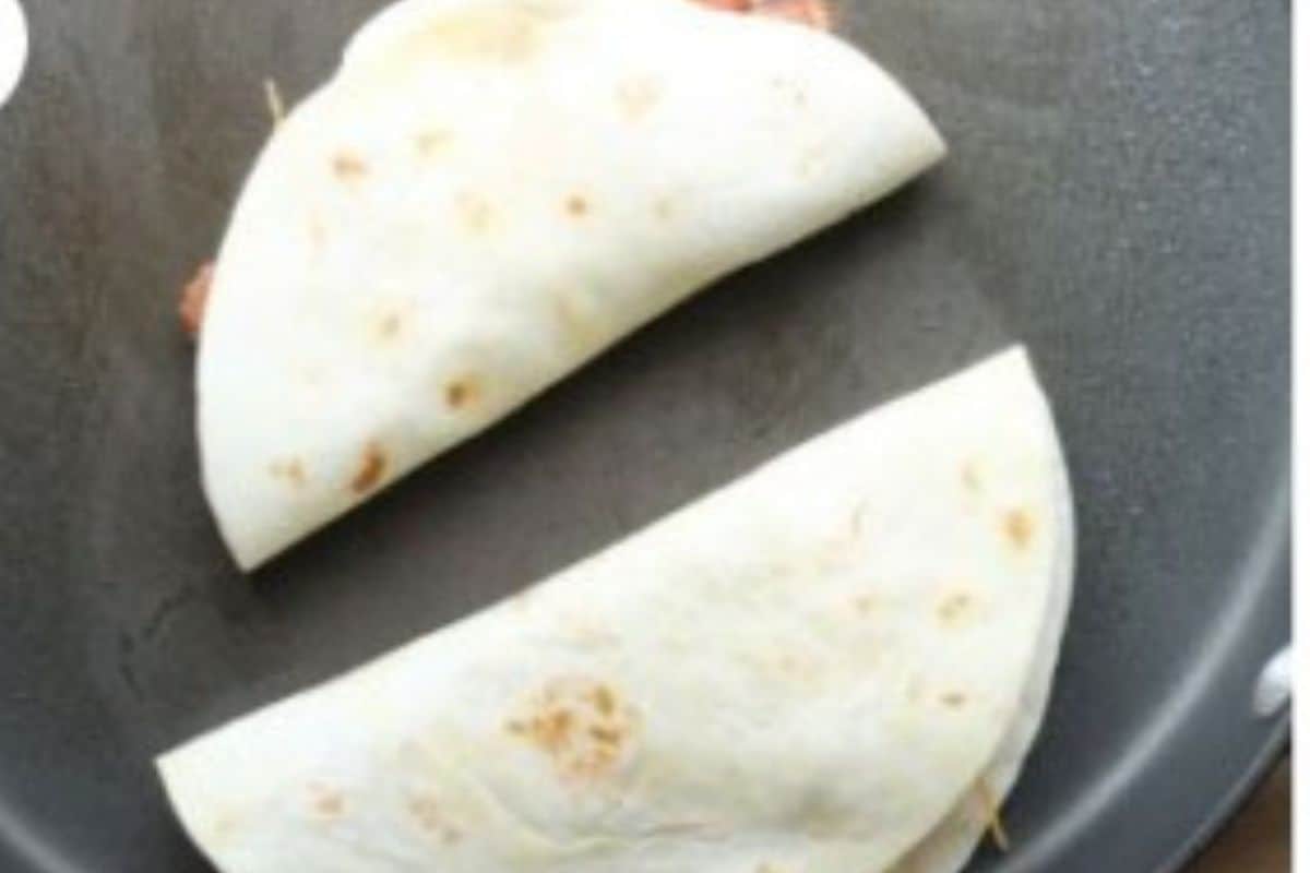 Vegetarian quesadillas in pan before flipping.