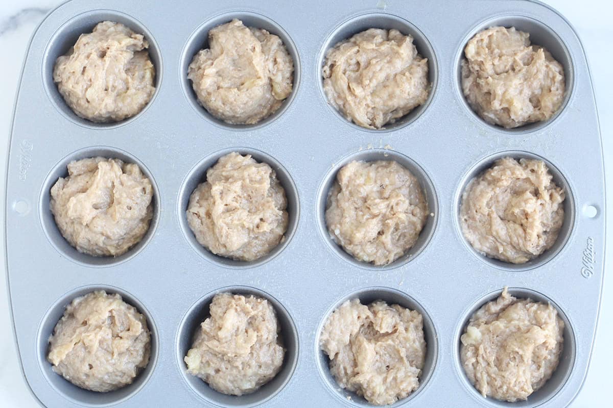 batter for banana bread muffins in baking pan.
