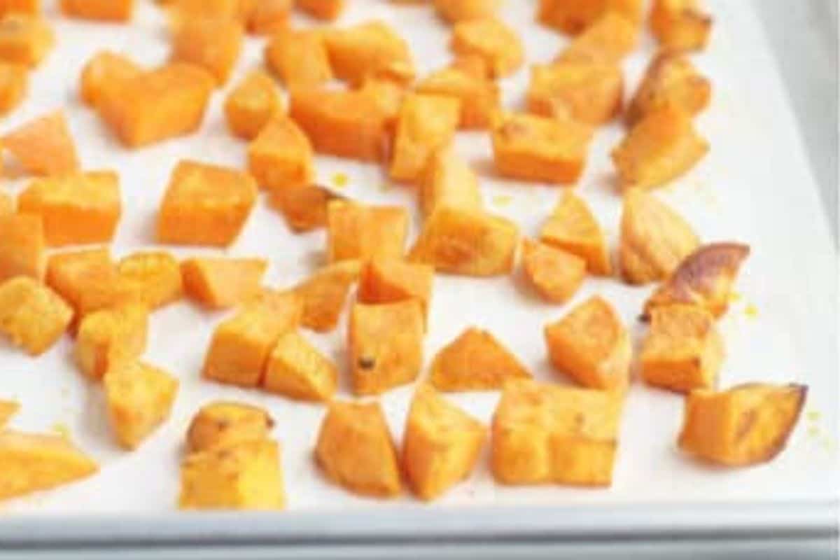 Roasted sweet potato on pan for vegetable enchiladas.
