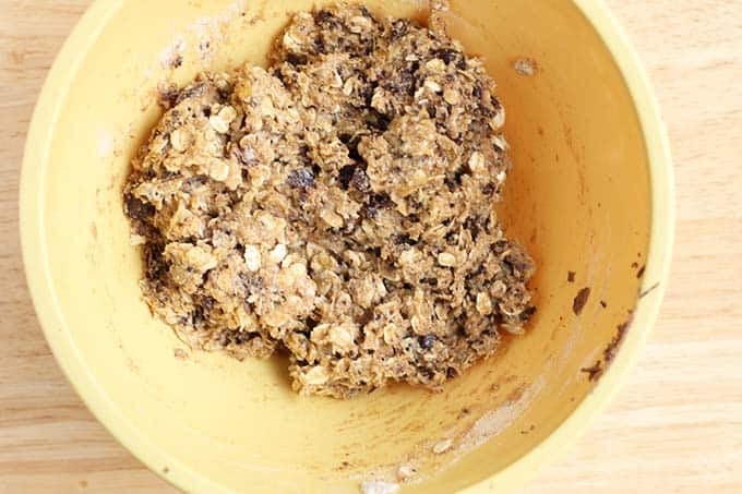 Batter for chocolate chip cookie cake in yellow bowl.