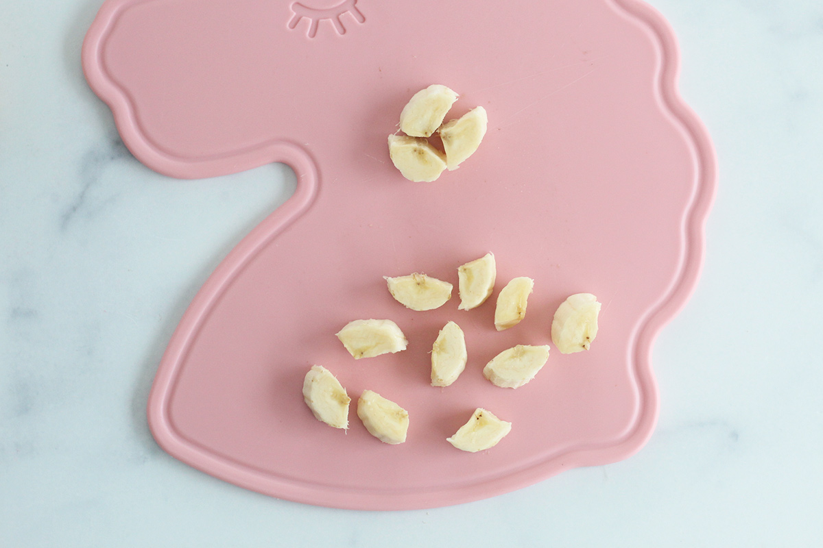 pieces of banana for baby on cutting board