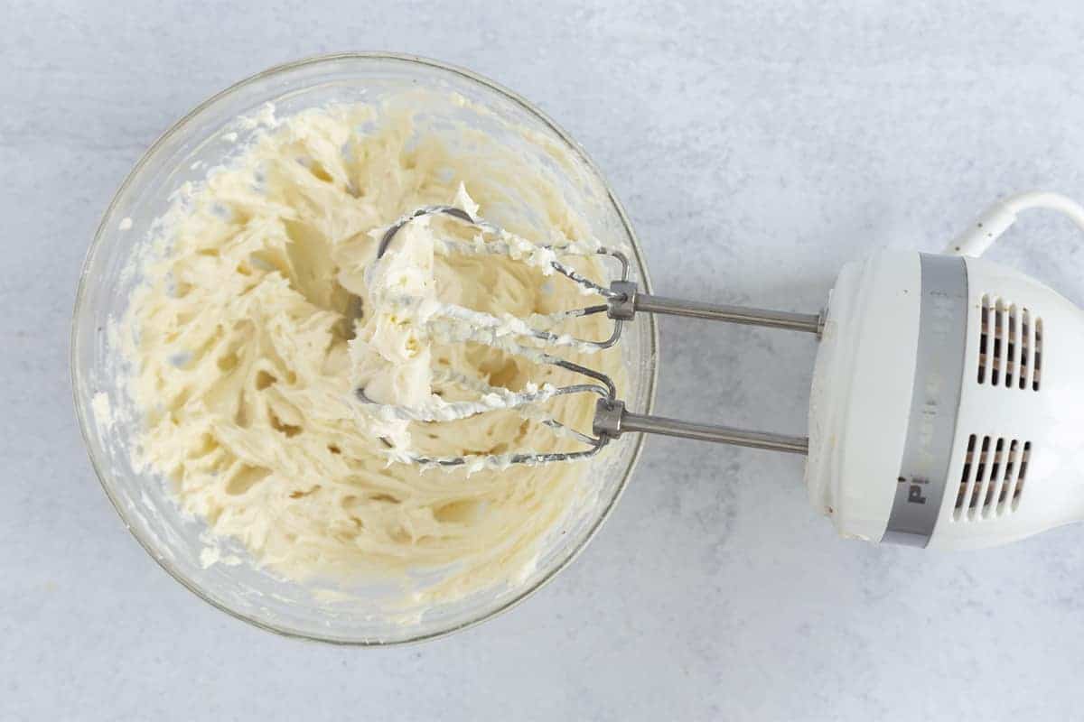 cream cheese frosting in bowl with mixer