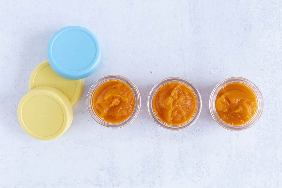 carrot baby food in jars on counter