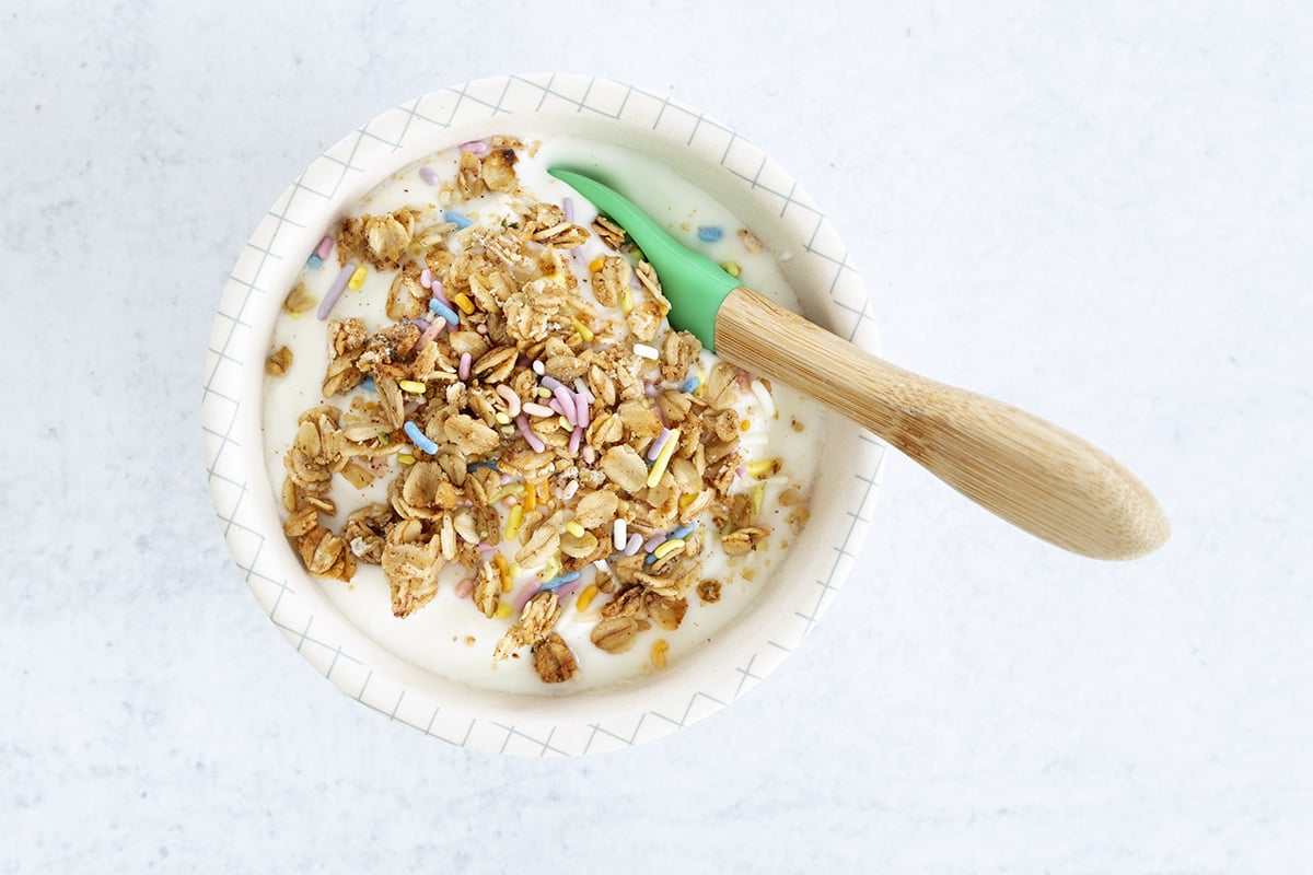 granola on yogurt in kids bowl