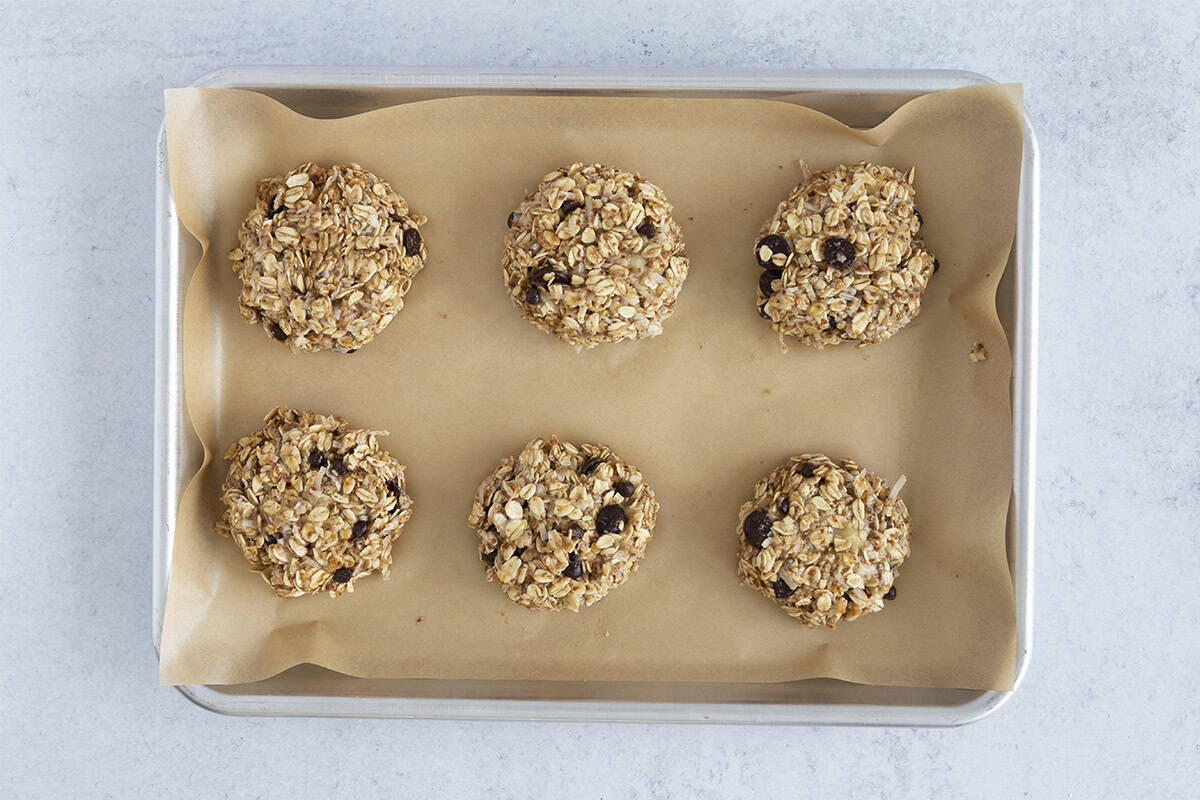 lactation cookies ready to bake on parchment lined baking sheet.