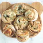 pizza rolls on wooden plate