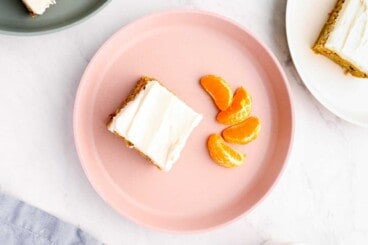 carrot cake bar on pink plate on countertop
