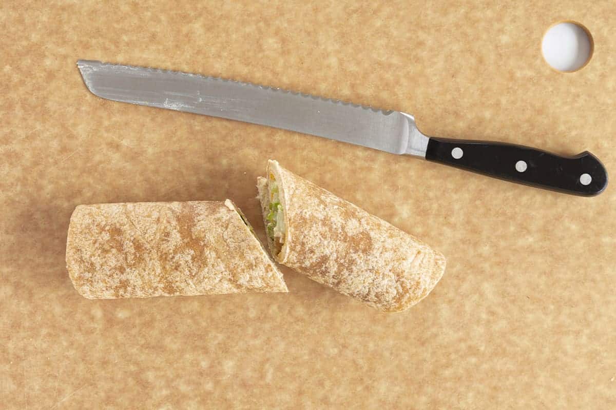 cutting hummus wrap in half