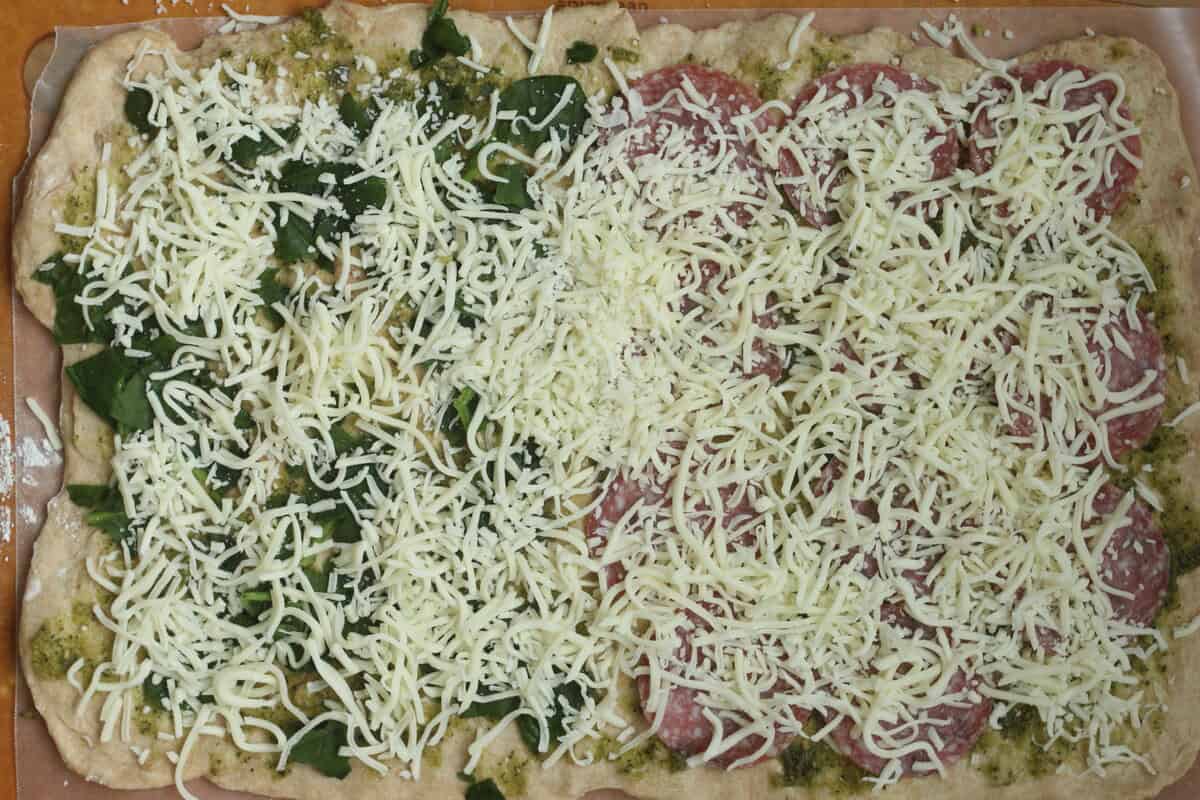 Pizza rolls with fillings before rolling up.