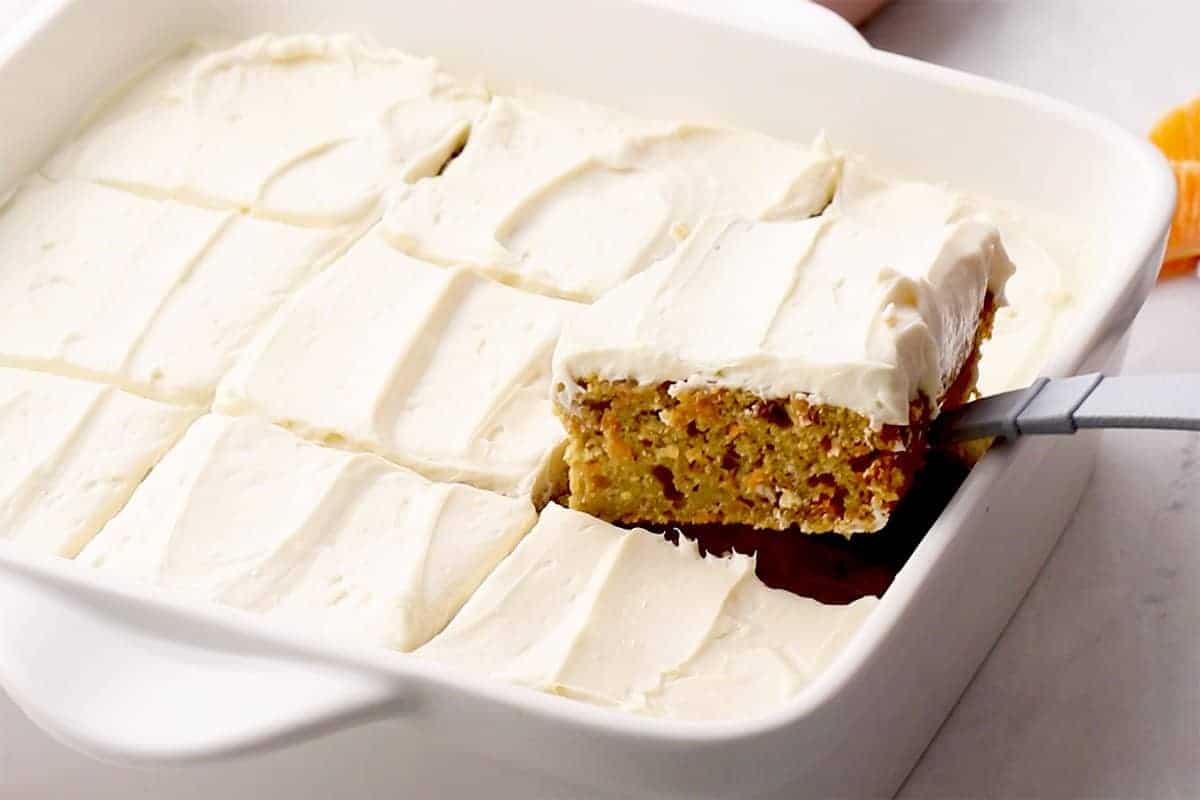 slice of carrot cake bar being lifted out of pan