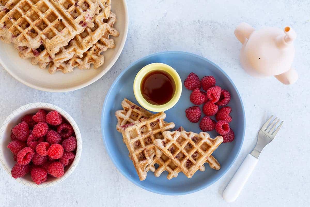 healthy waffles on blue plate with raspberries