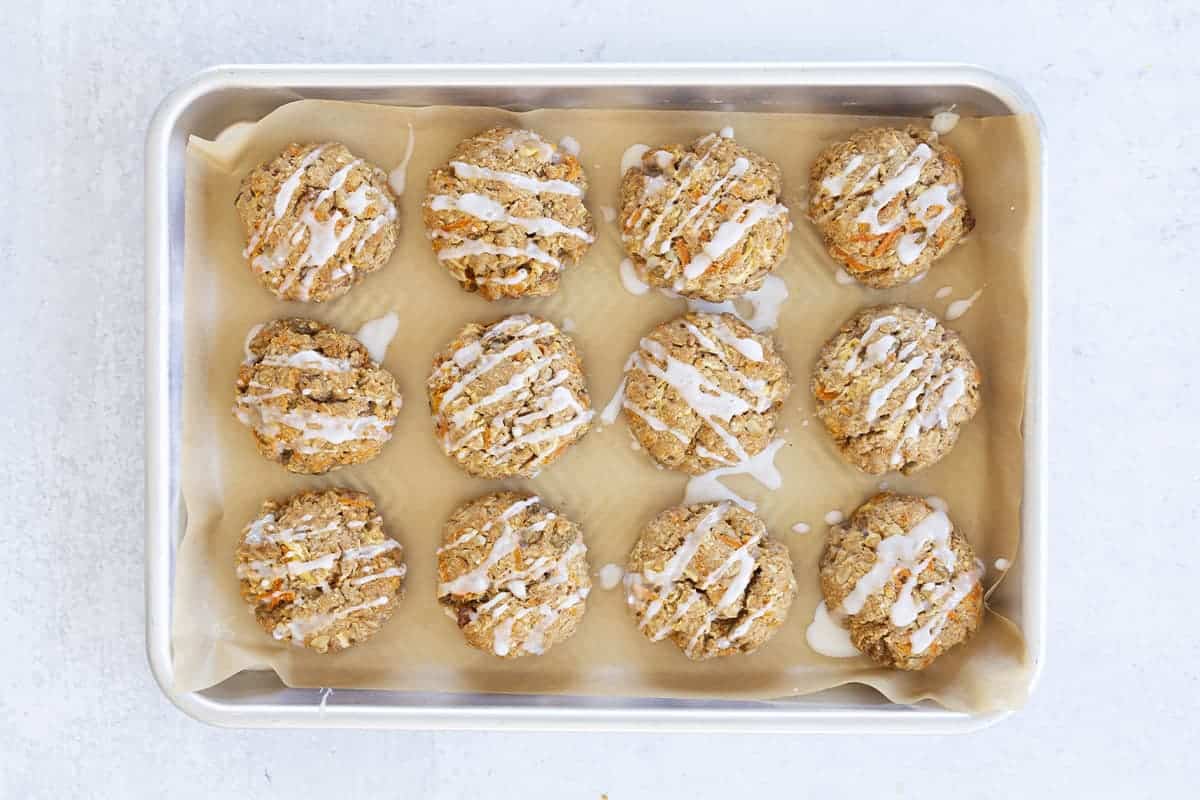 healthy oatmeal cookies with apples and carrots on tray.