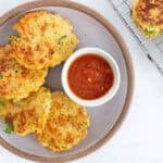 quinoa patties on purple plate with dip.