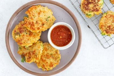 quinoa patties on purple plate with dip.