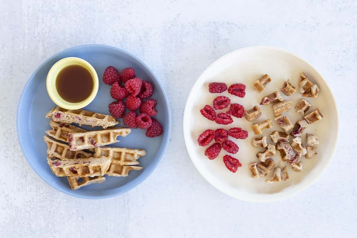 healthy waffles on two plates with berries